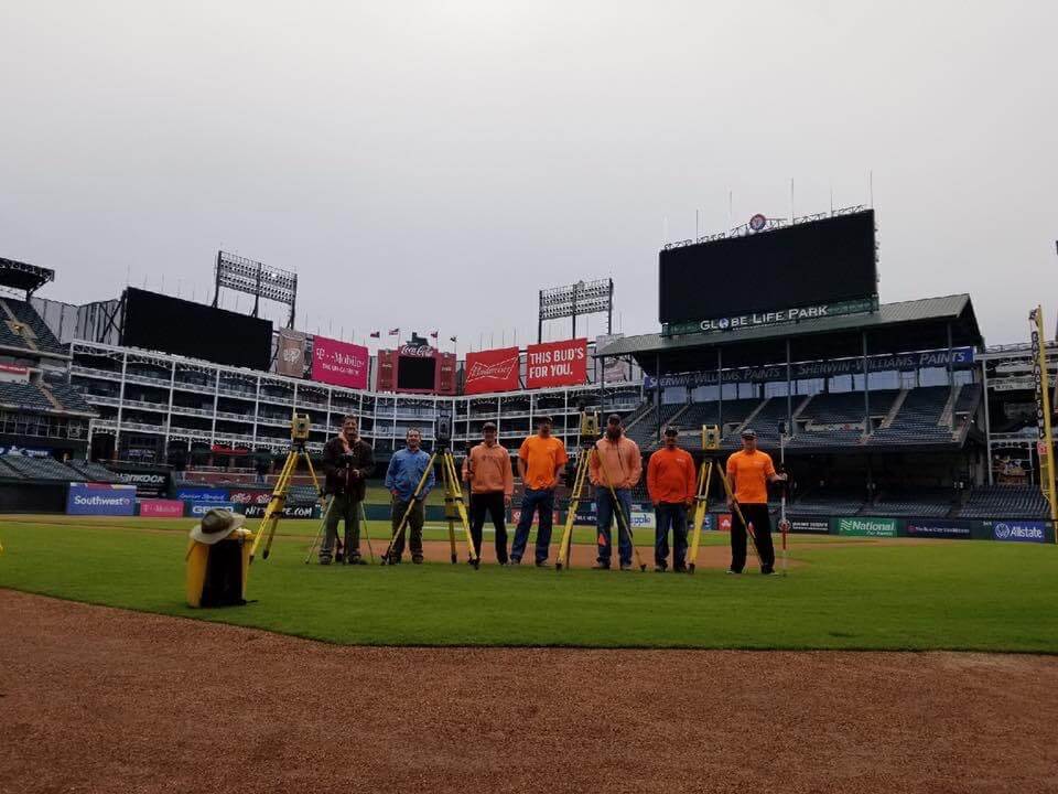 Roome Land Surveying field crews with their instruments on the field at Globe Life Park in Arlington
