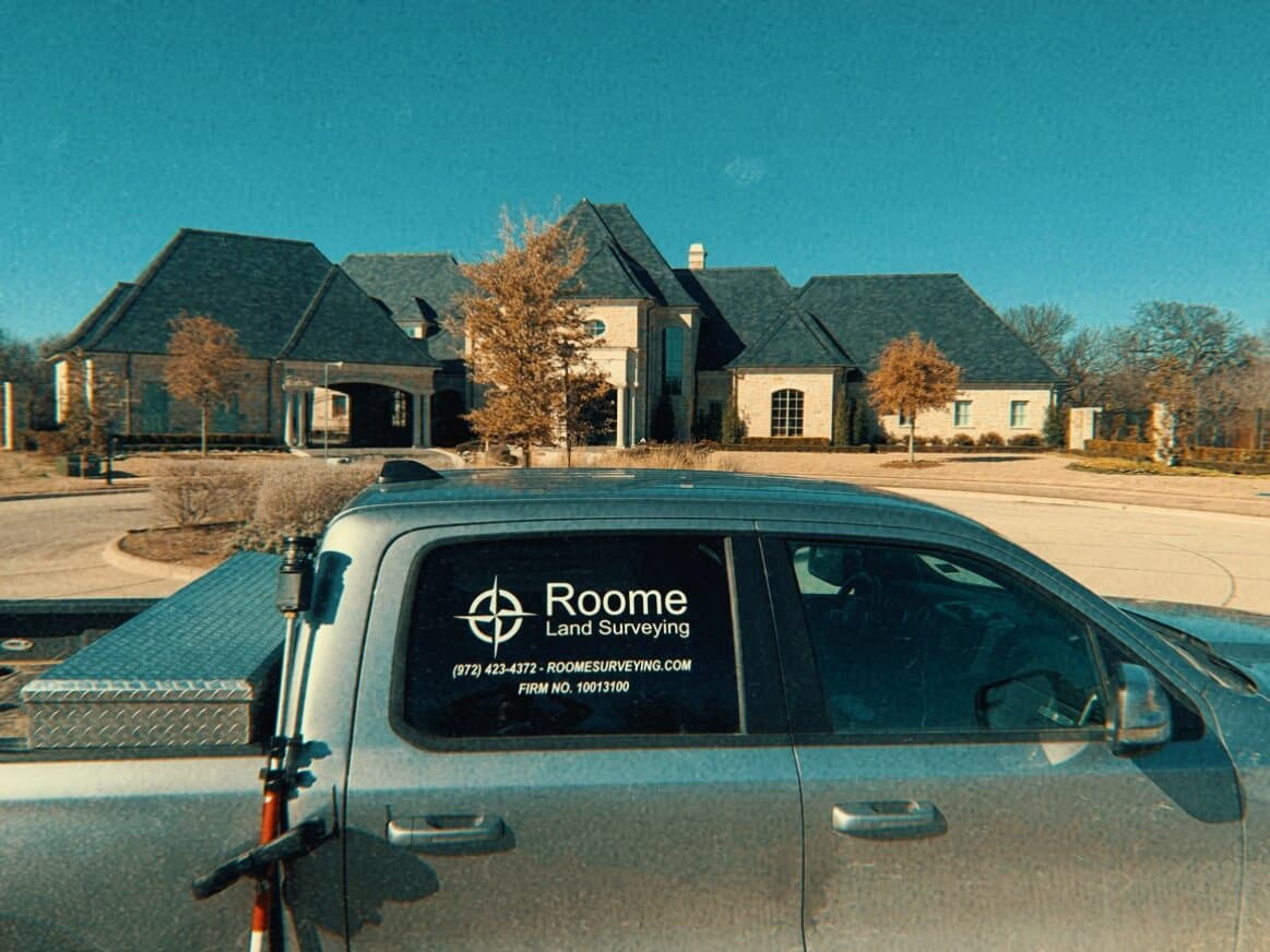 Roome Land Surveying truck parked in front of a North Central Texas home during a residential survey